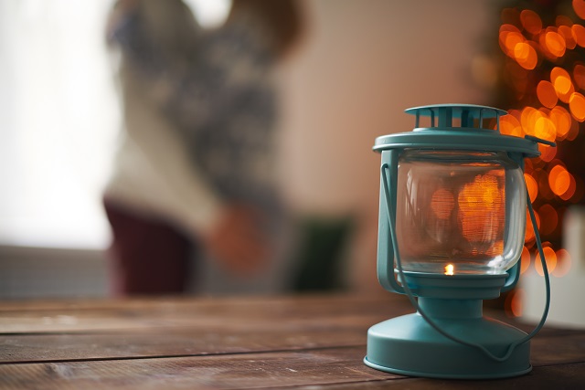 Lantern on wooden table on background of lovers